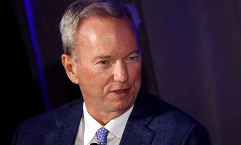 Eric Schmidt, former Google CEO, in a blue suit.