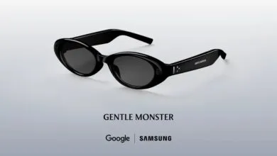 Black Gentle Monster sunglasses with dark lenses on a light gray background.