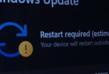 Windows Update screen showing 'Restart required' message with a yellow warning icon.