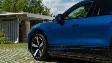 Close-up of a blue Porsche Cayenne Coupe Turbo with black accents.