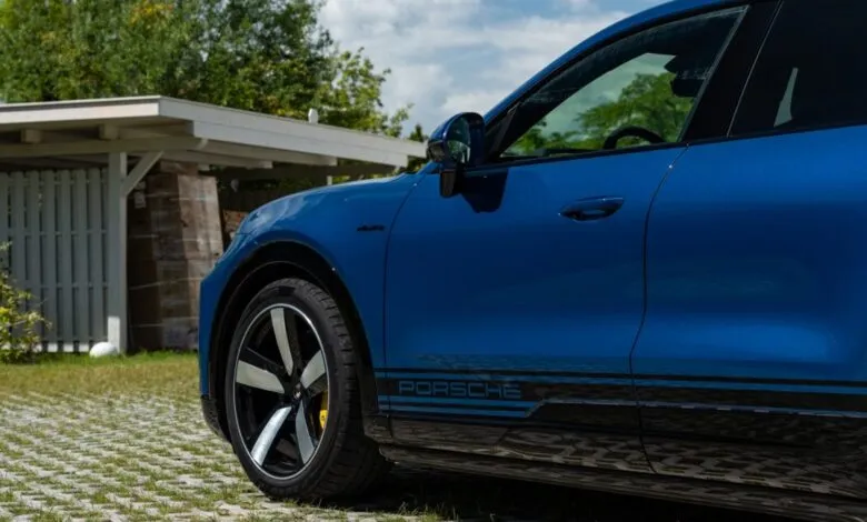 Close-up of a blue Porsche Cayenne Coupe Turbo with black accents.