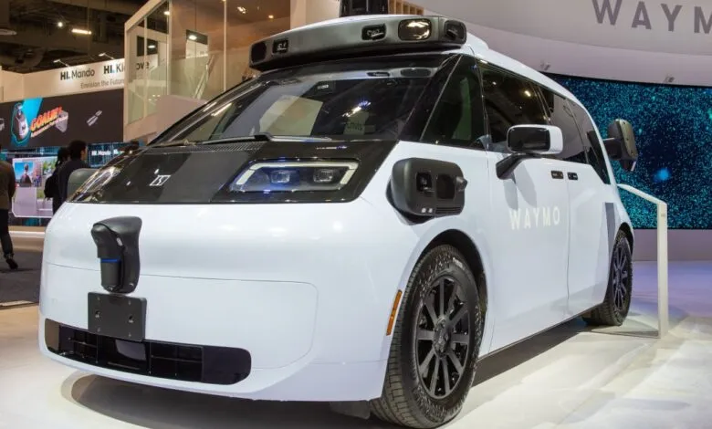 Waymo self-driving vehicle on display at an exhibition.