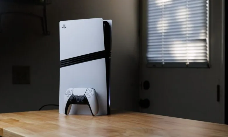 PlayStation 5 console and controller on a wooden surface.