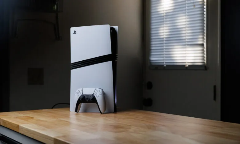 PlayStation 5 console and controller on a wooden countertop.