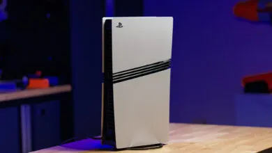 PlayStation 5 console standing vertically on a wooden surface.