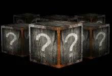 Six wooden crates with question marks on a black background.
