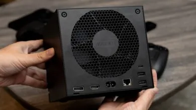 Valve PC gaming console held, showing ports and fan grill.