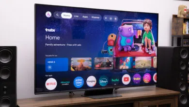 Hisense UR9 RGB LED TV displaying Tubi Home interface on a wooden stand.