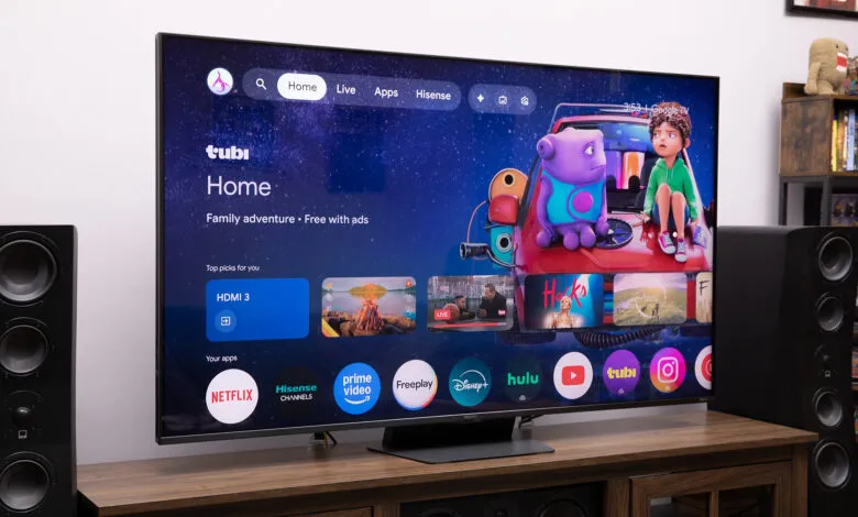 Hisense UR9 RGB LED TV displaying Tubi Home interface on a wooden stand.