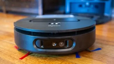 Dyson 360 Vis Nav robot vacuum cleaner on a wooden floor.