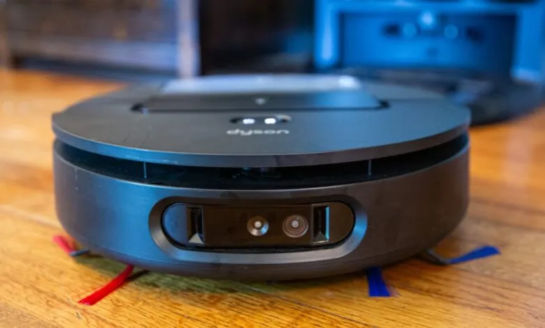 Dyson 360 Vis Nav robot vacuum cleaner on a wooden floor.