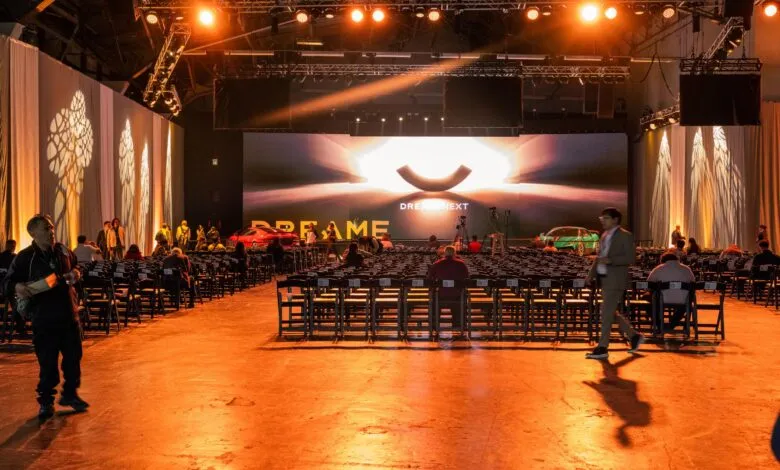Event space with rows of chairs facing a stage with 'DREAME NEXT' displayed.