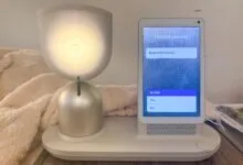 ElliQ robot on a table, screen displays 'Rose and Cookie' and 'Tell ElliQ'