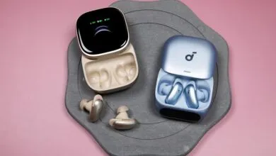 Soundcore Liberty 5 Pro earbuds in open charging cases, gold and blue.