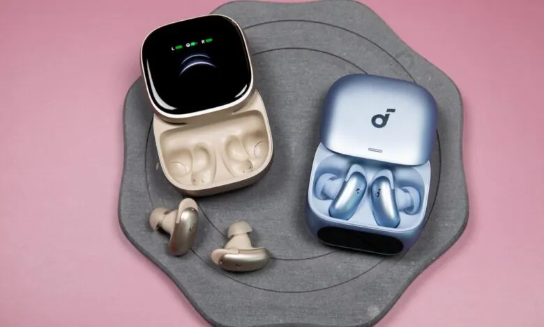 Soundcore Liberty 5 Pro earbuds in open charging cases, gold and blue.