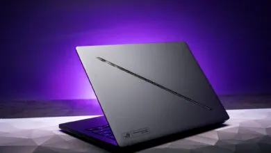 Asus ROG Zephyrus G14 laptop with a sleek gray design and purple backlight.
