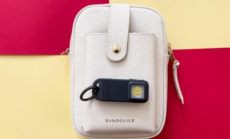Pebblebee Halo tracker attached to a Bandolier crossbody bag.