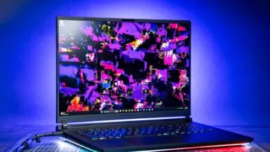Asus ROG Strix Scar 18 laptop with vibrant abstract art on screen.