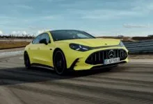 Yellow Mercedes-AMG GT 63 4-Door Coupé driving on a racetrack.