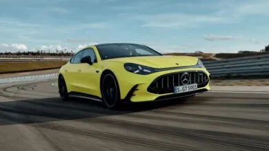 Yellow Mercedes-AMG GT 63 4-Door Coupé driving on a racetrack.