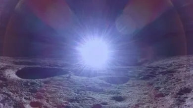 Lunar surface with craters illuminated by a bright, central light source.