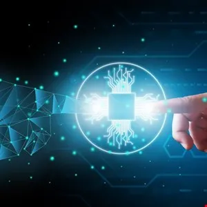 Human finger touches glowing circuit board icon, with a digital hand nearby, on a dark background.