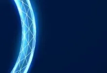 Abstract glowing blue ring with geometric pattern against a dark blue background.