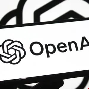 Close-up of a phone displaying the OpenAI logo and text.