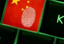 Keyboard key with Chinese flag and fingerprint overlay, symbolizing digital surveillance.