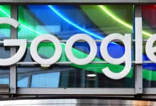 Google logo displayed against a colorful, modern glass facade.