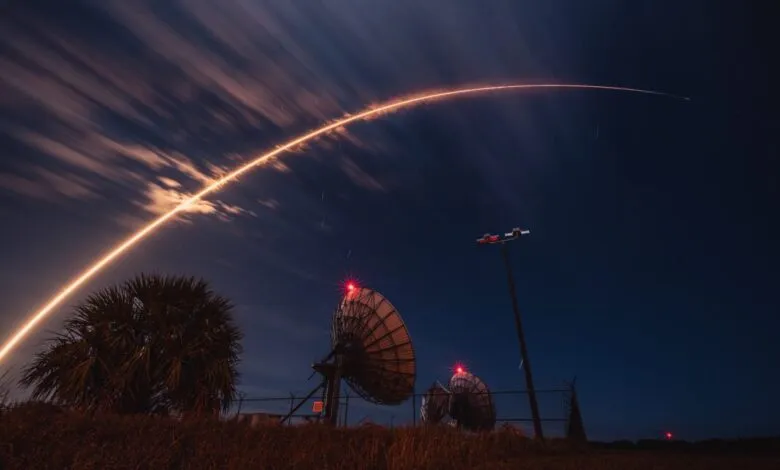 Long exposure shows Falcon 9 rocket launch with bright trail against night sky.