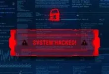 "System Hacked!" message overlaid on a screen filled with code, indicating a security breach.