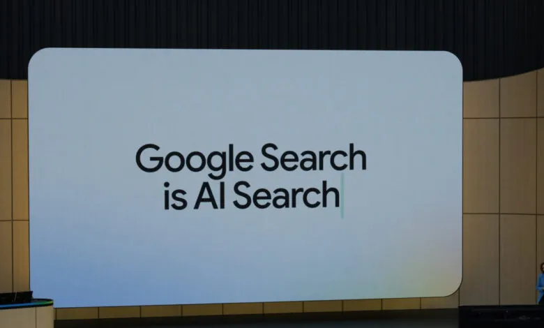 Large screen displays 'Google Search is AI Search' at a conference.