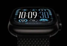 Close-up of a black Apple Watch Ultra 2 displaying time and various metrics.