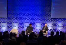 Two speakers on stage at MIT Technology Review event, audience present.