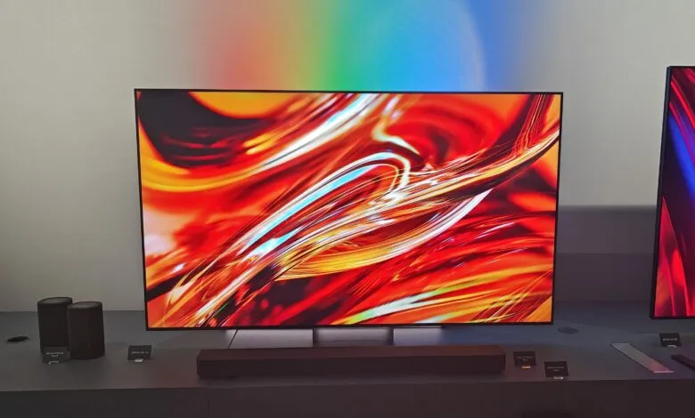 Sony BRAVIA TVs and soundbar on display with vibrant abstract art.