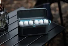 BioLite SiteLights in case on table with lantern, ready for camping.