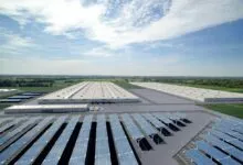 Aerial view of a large industrial park with solar panels and warehouses.