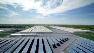 Aerial view of a large industrial park with solar panels and warehouses.
