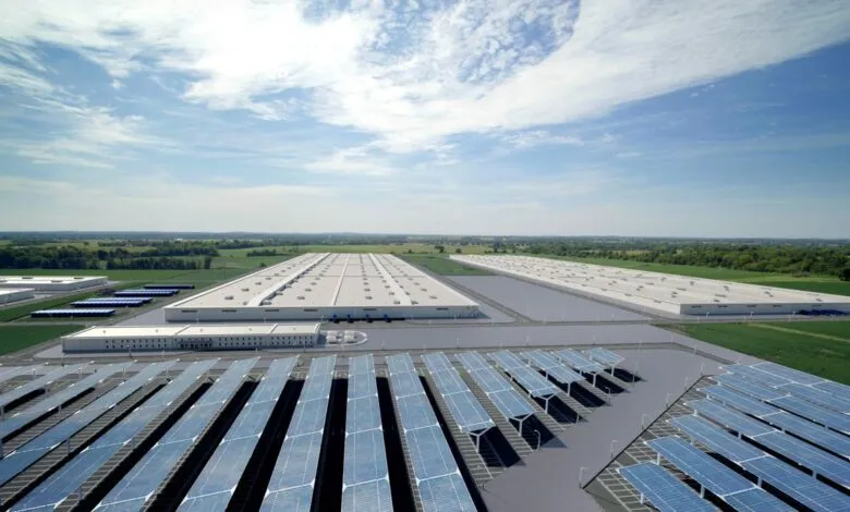 Aerial view of a large industrial park with solar panels and warehouses.