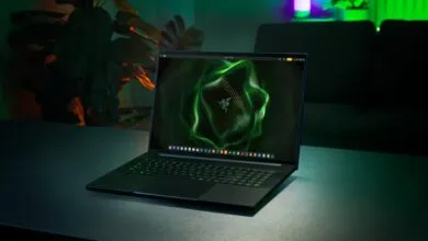 Razer Blade laptop with green glowing keyboard and screen display.