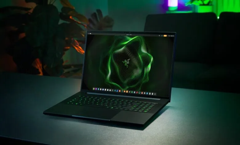 Razer Blade laptop with green glowing keyboard and screen display.