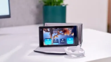 Device displaying 'Personalization' and ergonomic settings on a desk.