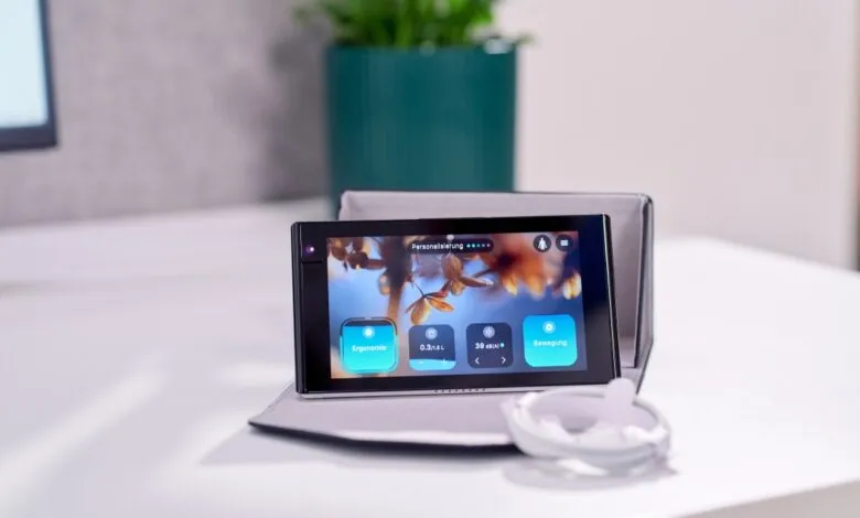 Device displaying 'Personalization' and ergonomic settings on a desk.