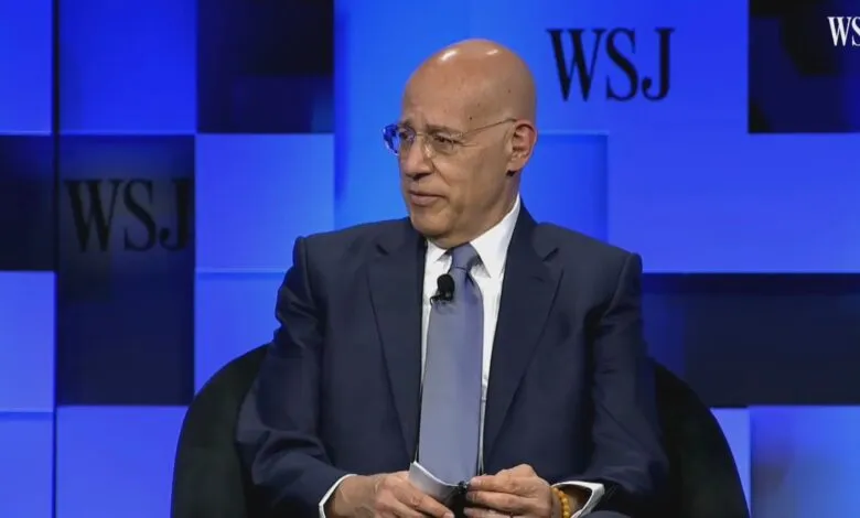 Peter Arnell at WSJ event, wearing suit and glasses.