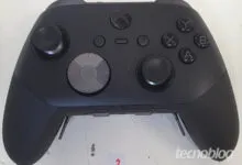 Close-up of a black Xbox Elite Series 2 controller on a white surface.