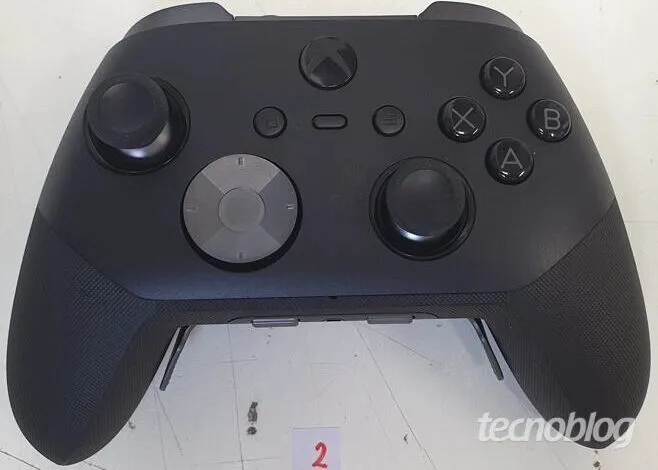 Close-up of a black Xbox Elite Series 2 controller on a white surface.