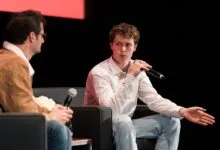 Ethan Thornton speaks at SVCSF 2025, gesturing with a microphone in hand.