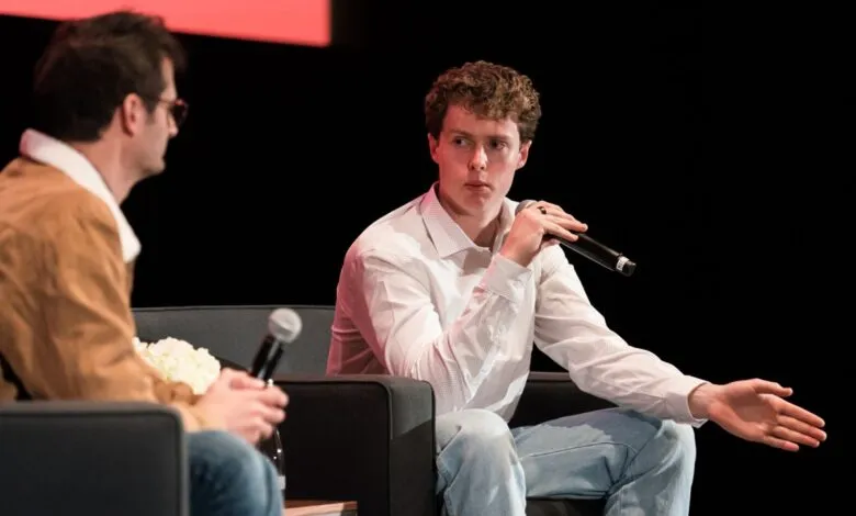 Ethan Thornton speaks at SVCSF 2025, gesturing with a microphone in hand.