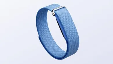 Light blue Fitbit band with silver buckle on a white background.